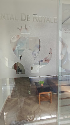 Dental De Royale glass entrance with clinic branding